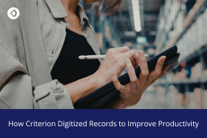 Person writing on a digital tablet inside a warehouse aisle, illustrating how Criterion digitized records to improve productivity.