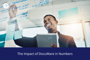 Person writing on a glass board filled with handwritten notes while holding a tablet, illustrating the impact of DocuWare in numbers.